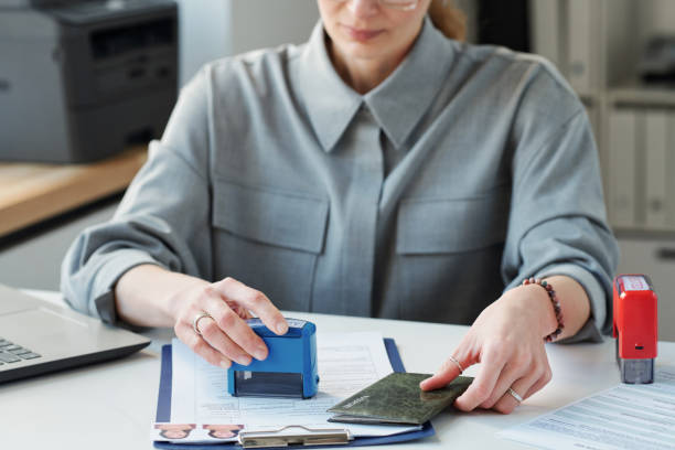 A woman stamps documents for a freelancer's visa application process in Dubai.