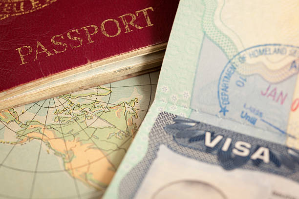 A passport and visa on a world map, symbolizing the visa and permit process for freelancers in Dubai in 2024.